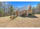 Exterior view of a cozy home with a metal roof and a spacious yard at 348 Raymond Tharrington Rd, Louisburg, NC 27549
