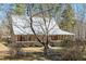 Charming tan home featuring a metal roof and large porch at 348 Raymond Tharrington Rd, Louisburg, NC 27549