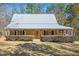 Charming home with welcoming porch and landscaped front yard at 348 Raymond Tharrington Rd, Louisburg, NC 27549