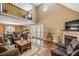 Bright living room with a fireplace, hardwood floors, loft and access to the outdoors at 348 Raymond Tharrington Rd, Louisburg, NC 27549