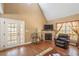 Comfortable living room boasting a fireplace, hardwood floors, and access to a patio at 348 Raymond Tharrington Rd, Louisburg, NC 27549