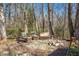 Outdoor patio area with stone pavers, seating, and fire pit at 348 Raymond Tharrington Rd, Louisburg, NC 27549