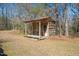 Rustic log shed with a small porch at 348 Raymond Tharrington Rd, Louisburg, NC 27549