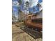 Back deck with a pergola offers shade and a great place to enjoy the wooded backyard at 355 Riverstone Dr, Clayton, NC 27527