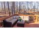 Back deck has outdoor seating and is perfect for enjoying the wooded view at 355 Riverstone Dr, Clayton, NC 27527