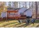 Backyard features a deck, fire pit with chairs, and plenty of space to enjoy the outdoors at 355 Riverstone Dr, Clayton, NC 27527