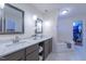 Bright bathroom features a double vanity, granite countertops, and access to the walk-in closet and large soaking tub at 355 Riverstone Dr, Clayton, NC 27527