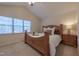 Serene bedroom featuring a bed with linens, a nightstand, and a bright window with great natural light at 355 Riverstone Dr, Clayton, NC 27527