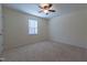 Neutral bedroom with plush carpeting, a window for natural light, and a ceiling fan at 355 Riverstone Dr, Clayton, NC 27527