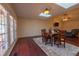 Inviting dining area with hardwood floors, a cozy rug, and skylights for abundant natural light at 355 Riverstone Dr, Clayton, NC 27527