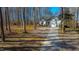 Well-maintained single-Gathering home featuring attached garage and long driveway among the trees at 355 Riverstone Dr, Clayton, NC 27527