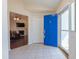 Bright foyer with tile flooring, a blue front door and views into the living area of the home at 355 Riverstone Dr, Clayton, NC 27527
