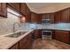 Close up of kitchen with stainless steel appliances, beautiful countertops and tile backsplash at 355 Riverstone Dr, Clayton, NC 27527
