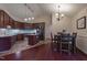 Eat-in kitchen with rich wood cabinetry, stainless steel appliances, and a granite countertop island at 355 Riverstone Dr, Clayton, NC 27527