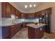 Well-equipped kitchen featuring stainless steel appliances, granite countertops, and dark wood cabinetry at 355 Riverstone Dr, Clayton, NC 27527
