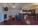 Inviting living room with a fireplace, TV, hardwood floors, and open layout into the dining and kitchen at 355 Riverstone Dr, Clayton, NC 27527