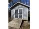 Gray backyard shed with ramp and double doors ideal for storage in residential location at 355 Riverstone Dr, Clayton, NC 27527