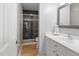Bathroom featuring black tiled shower, white vanity, and modern fixtures at 3803 Chimney Ridge Pl # 102, Durham, NC 27713