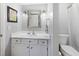 Well-lit bathroom featuring a white vanity, framed mirror, and neutral decor at 3803 Chimney Ridge Pl # 102, Durham, NC 27713