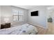 Comfortable bedroom with wood floors, a large window, and a mounted TV at 3803 Chimney Ridge Pl # 102, Durham, NC 27713