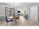 Dining room with new flooring, neutral paint, updated chandelier, and sliding glass doors at 3803 Chimney Ridge Pl # 102, Durham, NC 27713