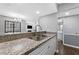Well-lit kitchen features granite countertops, stainless sink, and access to dining and bathrooms at 3803 Chimney Ridge Pl # 102, Durham, NC 27713