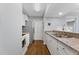 Updated kitchen with white cabinets, granite counters, stainless appliances, and wood floors at 3803 Chimney Ridge Pl # 102, Durham, NC 27713