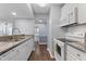 Efficient kitchen layout with white appliances, granite counters, and hardwood flooring at 3803 Chimney Ridge Pl # 102, Durham, NC 27713