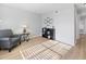 Sun-drenched living room is furnished with gray club chair, end table, and bookshelf at 3803 Chimney Ridge Pl # 102, Durham, NC 27713