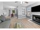 Open floor plan with fireplace, TV, dining area, and new flooring throughout at 3803 Chimney Ridge Pl # 102, Durham, NC 27713