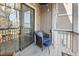 Cozy balcony featuring a comfortable chair, footstool, and outdoor lighting at 3803 Chimney Ridge Pl # 102, Durham, NC 27713