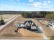 Expansive aerial view of the house with a pool and fire pit sitting on a large manicured lot with a long driveway at 3805 Barberry Lake Ct, Fuquay Varina, NC 27526