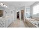 Bright bathroom featuring double vanity, large soaking tub and glass enclosed shower at 3805 Barberry Lake Ct, Fuquay Varina, NC 27526