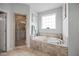 Bright bathroom featuring large soaking tub and glass enclosed shower at 3805 Barberry Lake Ct, Fuquay Varina, NC 27526
