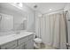 Bright bathroom featuring a modern vanity, marble countertops, and tile floors at 3805 Barberry Lake Ct, Fuquay Varina, NC 27526