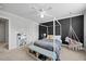 This bedroom features gray accent wall, canopy bed, ceiling fan and natural lighting at 3805 Barberry Lake Ct, Fuquay Varina, NC 27526