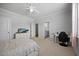 Neutral bedroom with ceiling fan, natural light, and light gray walls at 3805 Barberry Lake Ct, Fuquay Varina, NC 27526