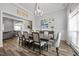 Bright dining room with modern lighting and a view of the living area at 3805 Barberry Lake Ct, Fuquay Varina, NC 27526