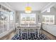 Bright dining room features hardwood floors, large windows, and a dining table with seating for six at 3805 Barberry Lake Ct, Fuquay Varina, NC 27526