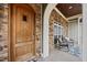 Covered front porch with seating area leading to a wood front door at 3805 Barberry Lake Ct, Fuquay Varina, NC 27526