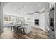 Bright open kitchen features white cabinets, stainless appliances, granite countertops, and large island with seating at 3805 Barberry Lake Ct, Fuquay Varina, NC 27526
