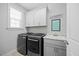 Laundry room with sink, front-load washer and dryer, and storage cabinets at 3805 Barberry Lake Ct, Fuquay Varina, NC 27526