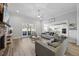 Open concept living area with fireplace and modern neutral-toned furnishings at 3805 Barberry Lake Ct, Fuquay Varina, NC 27526