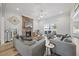 Living area features a stone fireplace, hardwood flooring, and contemporary furnishings at 3805 Barberry Lake Ct, Fuquay Varina, NC 27526