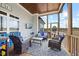 Screened porch featuring outdoor seating, ceiling fan, tv, and wooded views at 3805 Barberry Lake Ct, Fuquay Varina, NC 27526