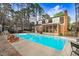 The in-ground pool enhances this brick home's idyllic, wooded backyard at 3836 Gloucester Rd, Rocky Mount, NC 27803