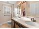 Bright bathroom with a double sink vanity, granite countertops, and neutral tile at 3836 Gloucester Rd, Rocky Mount, NC 27803