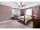 Spacious bedroom features a ceiling fan, two windows, and soft carpet at 3836 Gloucester Rd, Rocky Mount, NC 27803