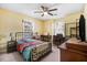 Bedroom features a ceiling fan, carpeted floor, and natural light from two windows at 3836 Gloucester Rd, Rocky Mount, NC 27803