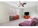 A cozy bedroom features a ceiling fan, carpeted floor, and a large window at 3836 Gloucester Rd, Rocky Mount, NC 27803